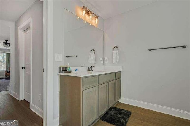 bathroom featuring vanity, a ceiling fan, baseboards, and wood finished floors