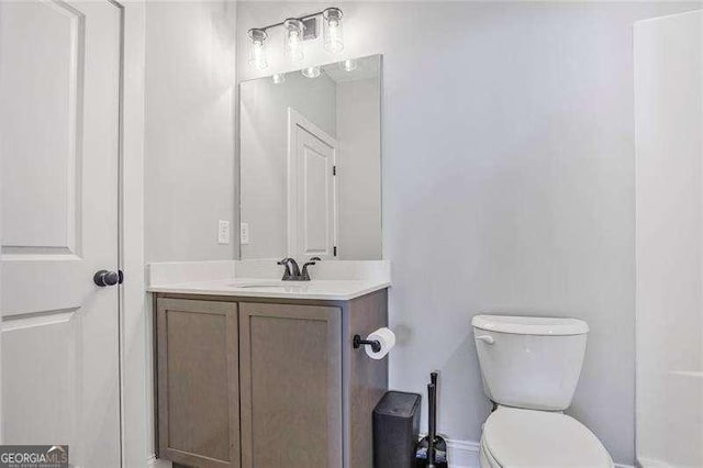 bathroom featuring toilet and vanity