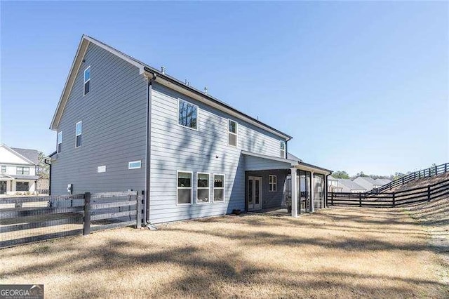 back of property featuring a fenced backyard