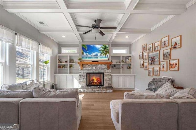 living area with ceiling fan, beam ceiling, a fireplace, wood finished floors, and coffered ceiling