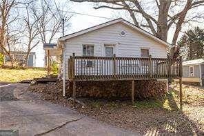 back of house featuring a wooden deck