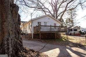 back of house with a wooden deck