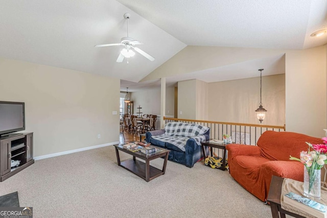 living area featuring baseboards, carpet floors, lofted ceiling, and a ceiling fan