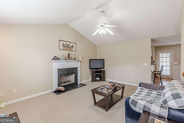 carpeted living room featuring baseboards, a fireplace with flush hearth, a ceiling fan, and lofted ceiling