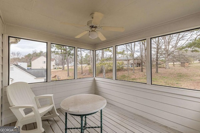 sunroom with a ceiling fan