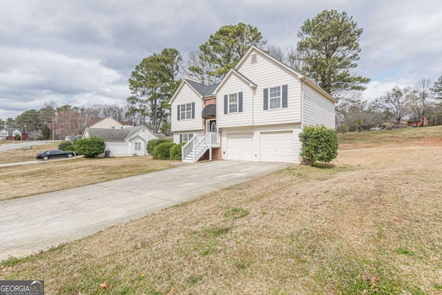 view of front of house with a front yard, a garage, and driveway