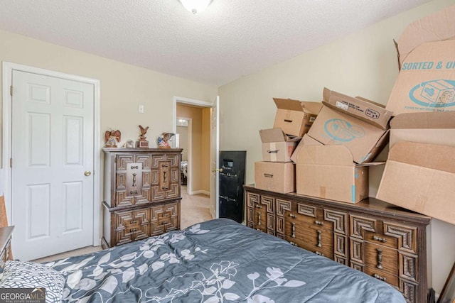 bedroom with carpet and a textured ceiling