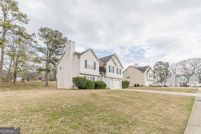 view of front of property with a front lawn, a residential view, concrete driveway, an attached garage, and a chimney