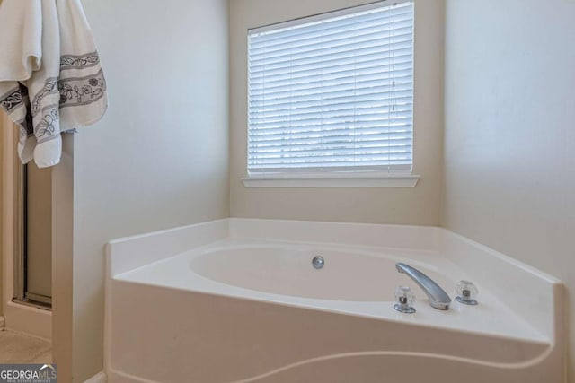 full bath featuring a bath and a shower with shower door