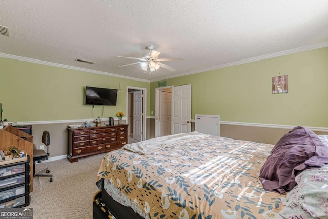 bedroom with visible vents, carpet floors, a textured ceiling, and ornamental molding