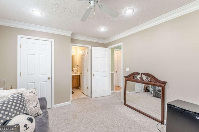 bedroom with light carpet, a textured ceiling, and crown molding