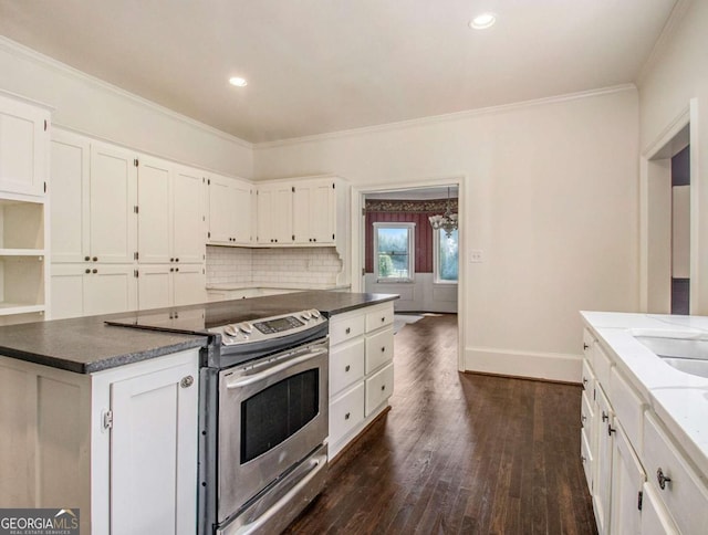 kitchen with electric range, dark wood-style flooring, white cabinets, and ornamental molding