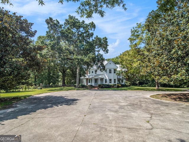 greek revival house featuring a front yard