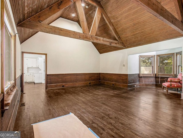 bonus room featuring beam ceiling, high vaulted ceiling, wood finished floors, wainscoting, and wood ceiling