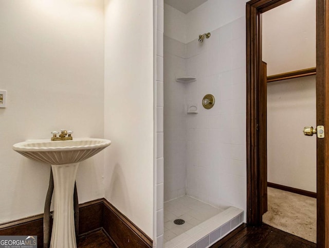 bathroom with baseboards and a stall shower