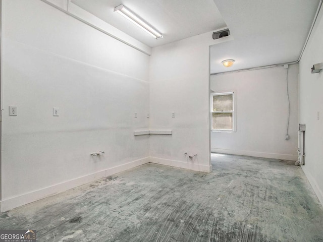 laundry area with baseboards