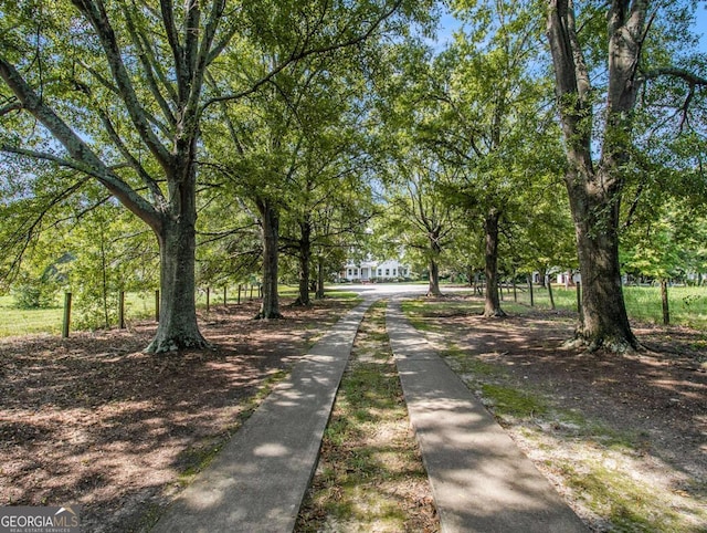 view of street featuring driveway and sidewalks