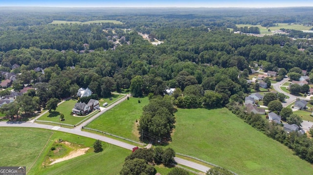 bird's eye view with a wooded view