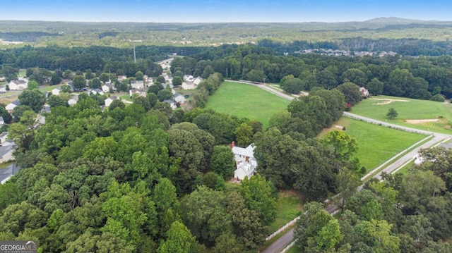 birds eye view of property featuring a view of trees