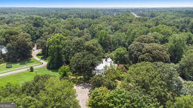 birds eye view of property with a wooded view