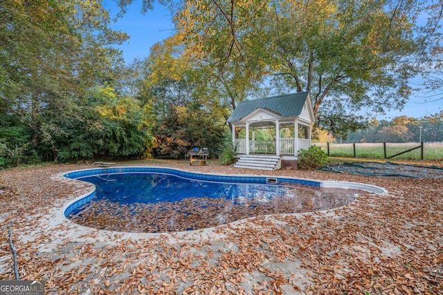 pool with a gazebo and fence