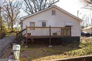 back of property featuring a wooden deck