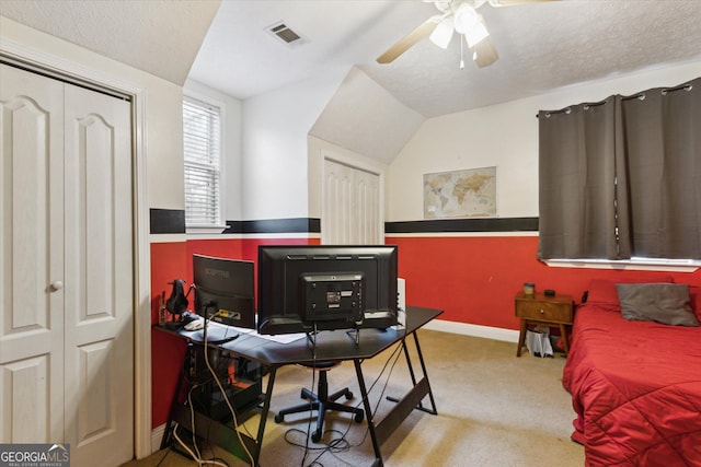 bedroom with visible vents, carpet, ceiling fan, and a textured ceiling