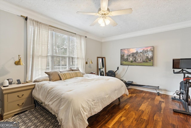 bedroom with wood finished floors, a textured ceiling, ornamental molding, and a ceiling fan