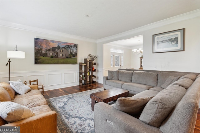 living area featuring ornamental molding, wainscoting, an inviting chandelier, wood finished floors, and a decorative wall