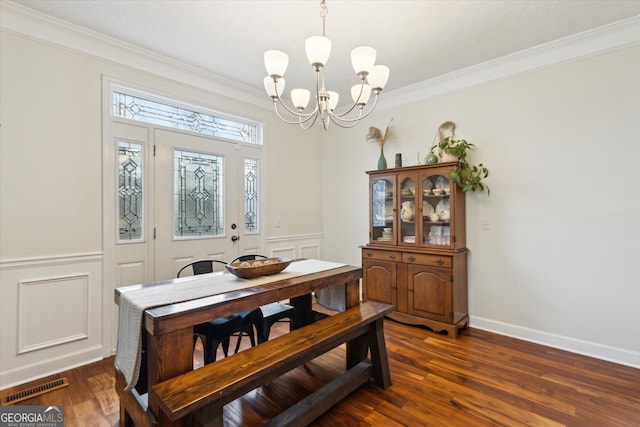 dining room featuring visible vents, a chandelier, dark wood finished floors, and crown molding