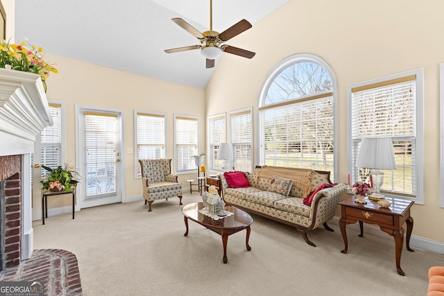 sunroom featuring lofted ceiling, ceiling fan, and a fireplace