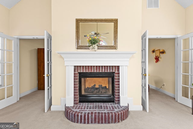 interior details featuring visible vents, french doors, a fireplace, and carpet floors