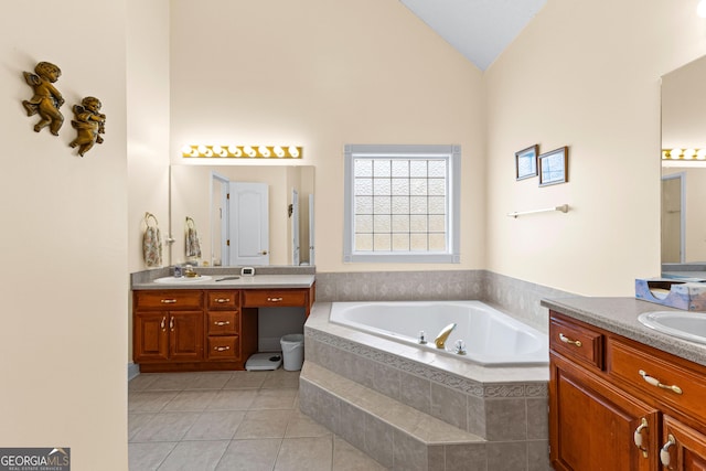 full bathroom featuring two vanities, lofted ceiling, a bath, and tile patterned floors