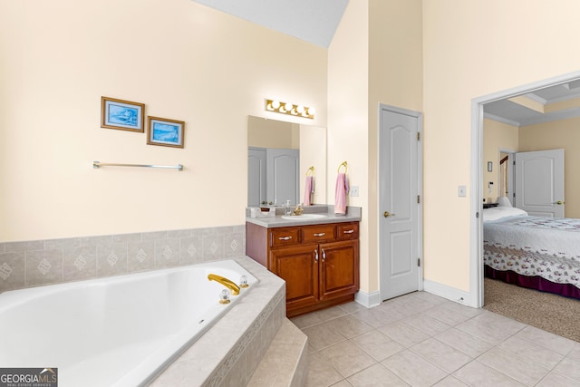 ensuite bathroom featuring tile patterned floors, a garden tub, ensuite bath, crown molding, and vanity