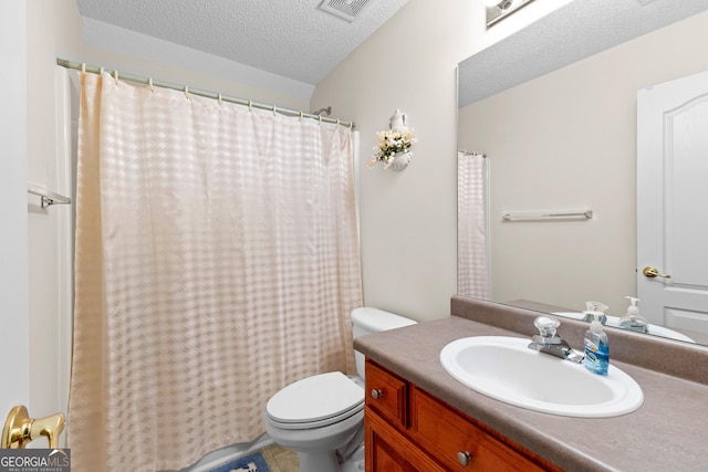 full bathroom with vanity, toilet, visible vents, and a textured ceiling