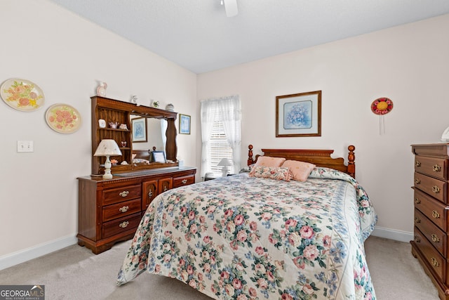 bedroom with light carpet, a ceiling fan, and baseboards