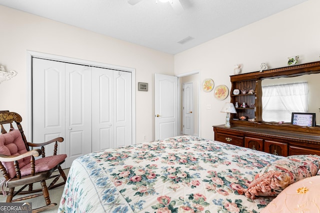 bedroom with visible vents, a closet, carpet floors, and ceiling fan