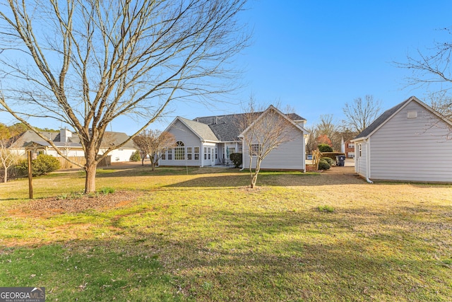 back of property featuring a yard