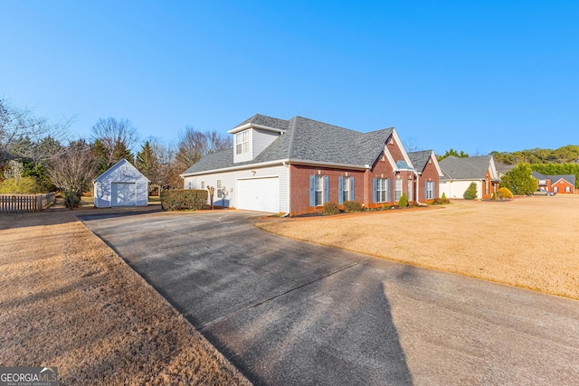 view of front of property featuring fence, brick siding, a front yard, and a shingled roof