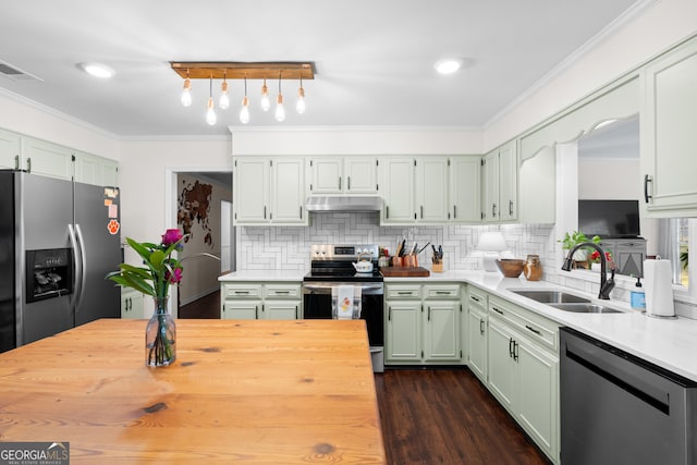 kitchen with visible vents, ornamental molding, a sink, under cabinet range hood, and appliances with stainless steel finishes