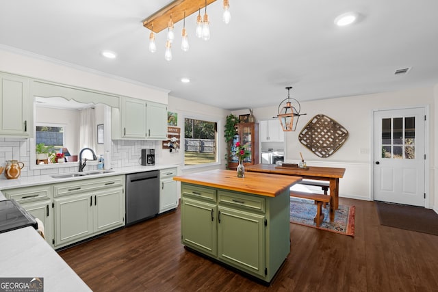 kitchen featuring visible vents, green cabinets, dishwasher, butcher block counters, and a sink