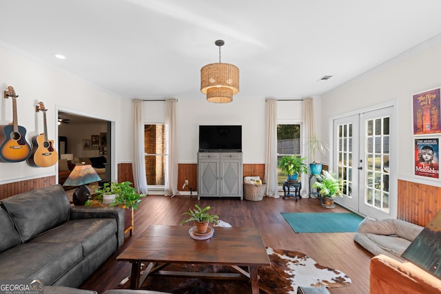 living area with wainscoting, french doors, crown molding, and hardwood / wood-style flooring