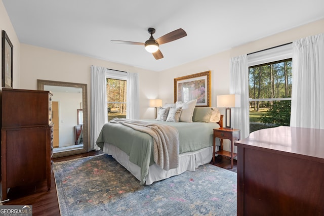 bedroom featuring dark wood-type flooring and a ceiling fan