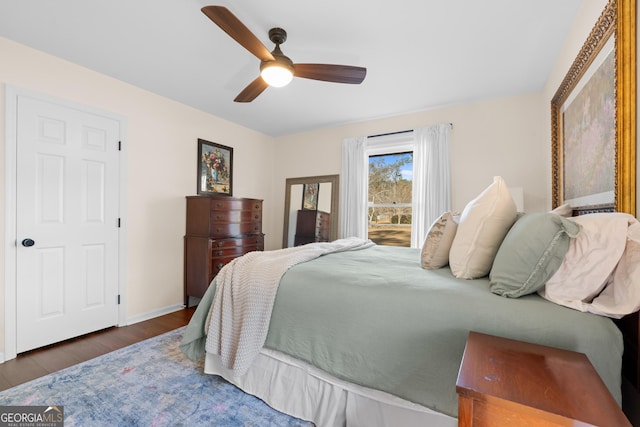 bedroom with baseboards, a ceiling fan, and wood finished floors