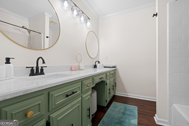 full bath featuring a sink, baseboards, wood finished floors, and ornamental molding