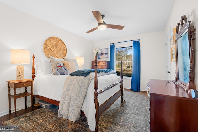 bedroom featuring ceiling fan, baseboards, and wood finished floors