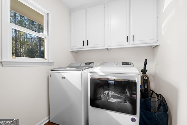 washroom with washer and dryer and cabinet space