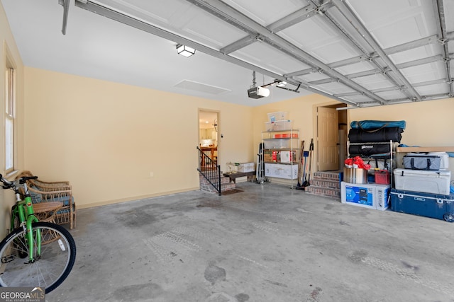 garage with a garage door opener and baseboards