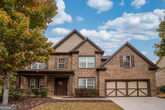 view of front of home featuring brick siding, an attached garage, and concrete driveway