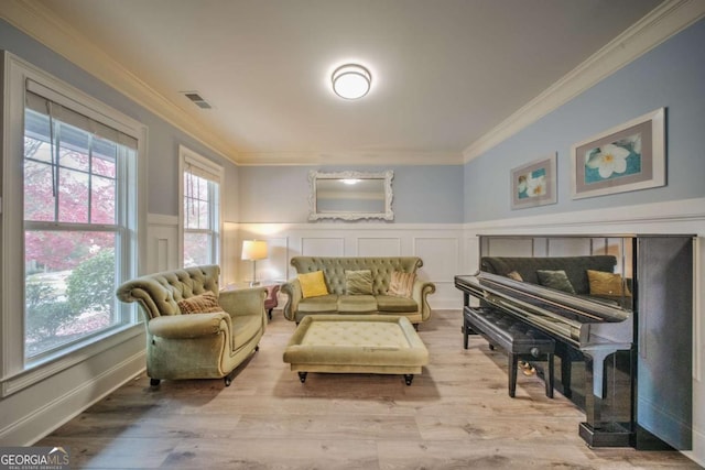 living area with visible vents, plenty of natural light, and crown molding